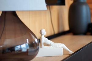 a small figurine sitting on top of a desk at Beim Dorfbach I DIE HOFCHALETS in Kressbronn am Bodensee