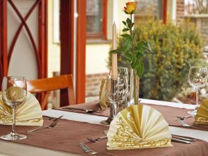 a table with a yellow flower in a vase on it at Penzion Fortune in Dunajská Streda