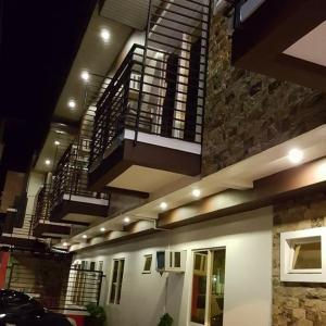 a building with stairs and a building with a car at Livewire Planet Suites in General Santos