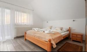 a bedroom with a bed with towels on it at Apartment Josipa in Seliste Dreznicko