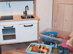 a kitchen with a sink and a table with a drawer at 12 person holiday home in Ulfborg in Husby