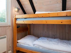 a bunk bed in a cabin with a bunk bed in a room at 8 person holiday home in R m in Kongsmark