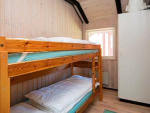 a bunk bed room with two bunk beds in a cabin at 8 person holiday home in R m in Kongsmark
