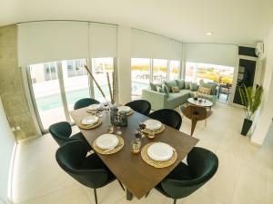 uma sala de jantar com uma mesa e cadeiras e um sofá em Imperial Jade Villas Gold Emerging Villas 2 em Protaras