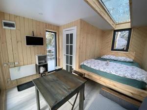 a bedroom with a bed and a table in a room at Greenvald Park Scandinavia in Ogon'ki