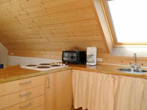 a kitchen with a counter top with a stove and a sink at 6 person holiday home in Ringk bing in Klegod