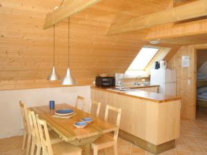 a kitchen and dining room with a wooden table at 6 person holiday home in Ringk bing in Klegod