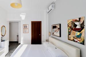 a white bedroom with two white beds in it at Aiello Suites Executive in Milan