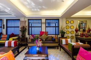 a living room with colorful furniture and windows at Viang Thapae Resort- SHA Extra Plus in Chiang Mai