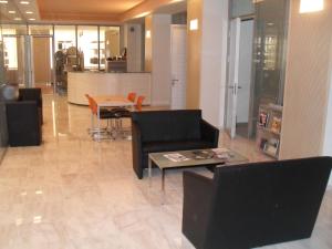 a living room with chairs and a table and a kitchen at HéberGement du POD in La Chaux-de-Fonds