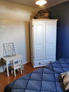 a bedroom with a bed and a table and a cabinet at Cépage de la Tourelle in Ways