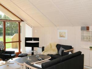 a living room with a couch and a table at 7 person holiday home in Ulfborg in Sønder Nissum
