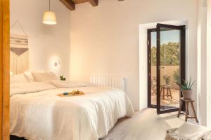 a bedroom with a bed with a stuffed animal on it at Mas Oms in Montnegre