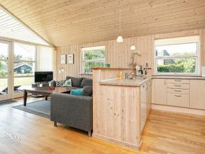 a kitchen and living room with a couch and a table at Seaside Retreat in Lolland - By Traum Ferienwohnungen in Dannemare +27 photos