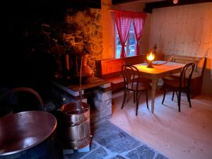 a dining room with a table and chairs and a candle at Schlafen im Fass - Schlaffass - Abenteuer - Romantik - Haslifass in Innertkirchen