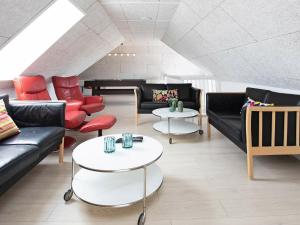 una sala de estar con sofás, mesas y un piano en 21 person holiday home in Bl vand, en Blåvand