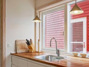 a kitchen with a sink and a window at 4 person holiday home in Gudhjem in Gudhjem
