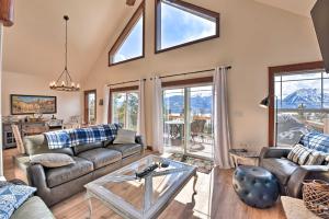 a living room with a couch and a table at Gorgeous Twin Lakes Home with Deck Overlooking Mtns! in Twin Lakes