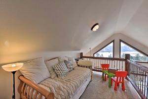 a living room with a couch on a balcony at Gorgeous Twin Lakes Home with Deck Overlooking Mtns! in Twin Lakes