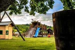 a playground with a slide in a park at restoran i prenoćište Egghus in Našice