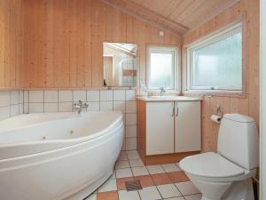 y baño con bañera, aseo y lavamanos. en 9 person holiday home in G rlev, en Venemose