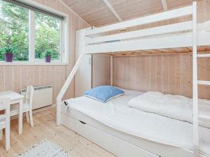 a bedroom with a bunk bed and a table and a desk at Five-Bedroom Holiday home in Juelsminde 1 in Slagelse
