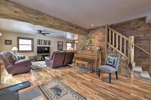 a living room with a staircase and a piano at Updated Mtn Home with Deck on Uncompahgre River in Ouray