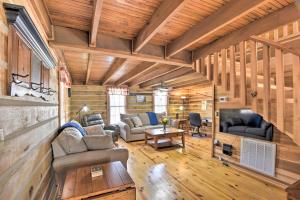 een woonkamer met houten wanden en houten vloeren bij The Lake Place Cabin with Golf Cart and Free Kayaks! in Lavonia