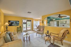 a living room with a couch and a table at Cape Coral Home with Yard Less Than 1 Mi to Dtwn! in Cape Coral