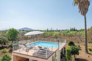 a villa with a swimming pool on top of a house at Can Nina in Campanet