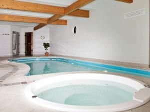 a large swimming pool with a large bath tub at 10 person holiday home in Bramming in Bramming