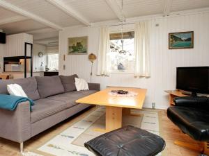a living room with a couch and a table at Three-Bedroom Holiday home in Læsø 4 in Læsø