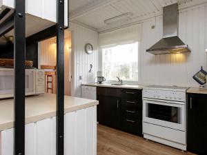 a kitchen with white appliances and a stove top oven at Three-Bedroom Holiday home in Læsø 4 in Læsø