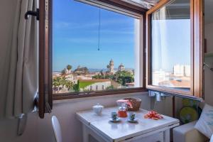 a table in a room with a large window at Il piccolo Attico in Oristano