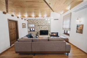 a living room with a couch and a tv at Elia City House in Kavála