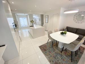 a kitchen and living room with a table and a couch at Summer House Terrace in Yeovil