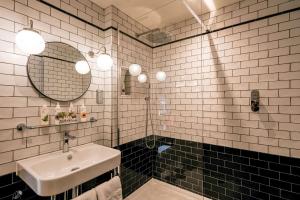 a bathroom with a sink and a mirror at The Park Hotel in Teddington