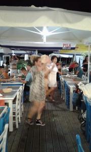 a group of people standing under a tent at Hotel Zografos in Paralia Katerinis