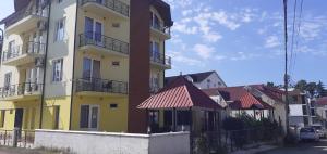 a yellow and white building with a row of houses at Villa Ureki in Ureki