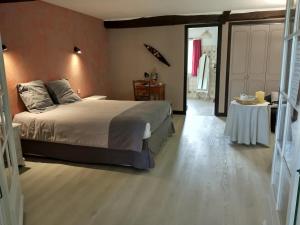 1 dormitorio con 1 cama grande y 1 mesa en Domaine Sainte Barthe, entre Marciac et Nogaro, en Aignan