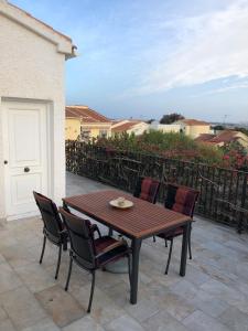 a wooden table and chairs on a patio at Sonniges Apartment an der Costa Blanca in San Fulgencio
