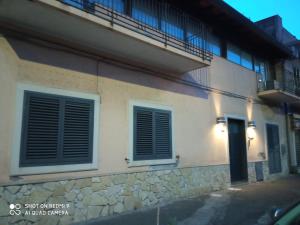 a building with two windows and a balcony at Fontanarossa Airport Home in Catania