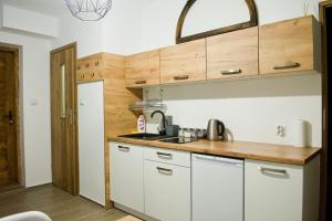 a small kitchen with white cabinets and a sink at GOLD-BOX in Nowy Targ