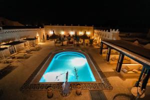 an overhead view of a swimming pool at night at Kasbah Mohayut in Merzouga