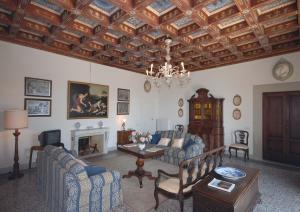 a living room with a couch and a fireplace at Villa Di Collina in Vicchio