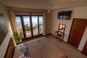 a living room with a view of the ocean at Villas Najo' Isla Mujeres. in Isla Mujeres
