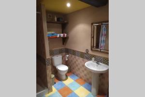 a bathroom with a toilet and a sink at LOS ORIZOS Sierra de Gata Extremadura TR-CC-00392 in Villamiel