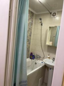 a bathroom with a tub and a sink and a shower at Апартаменты на ГОГОЛЯ,460 in Cherkasy