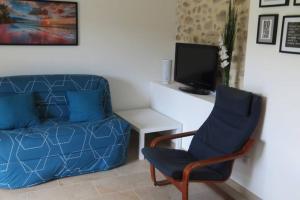a living room with a couch and a chair at Les châtaigniers du Thaurac in Saint-Bauzille-de-Putois