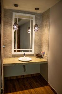 a bathroom with a sink and a mirror at Hotel Casa Texel in Panajachel